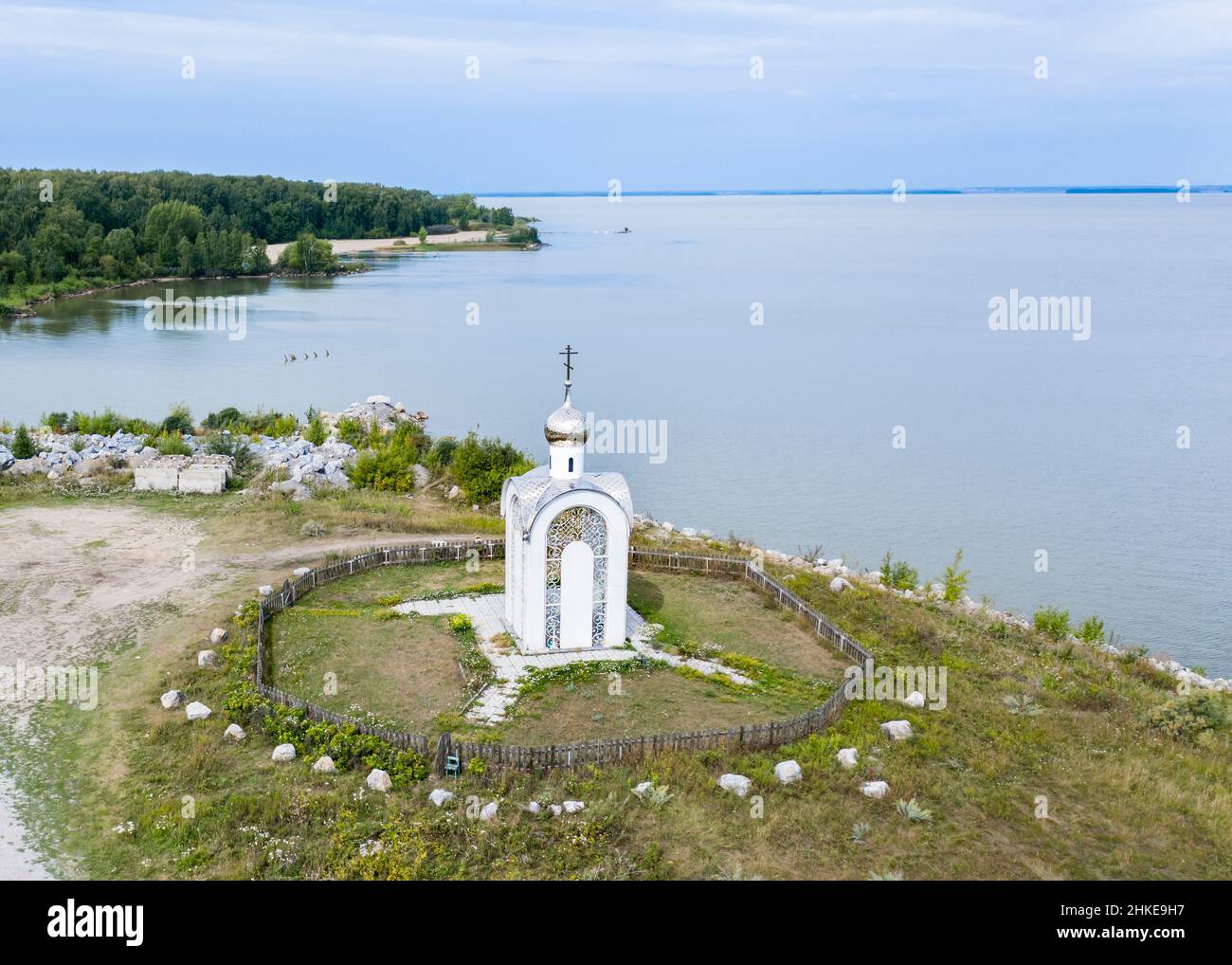 Aerial view of the white Christian chapel on the banks of the Ob River ...