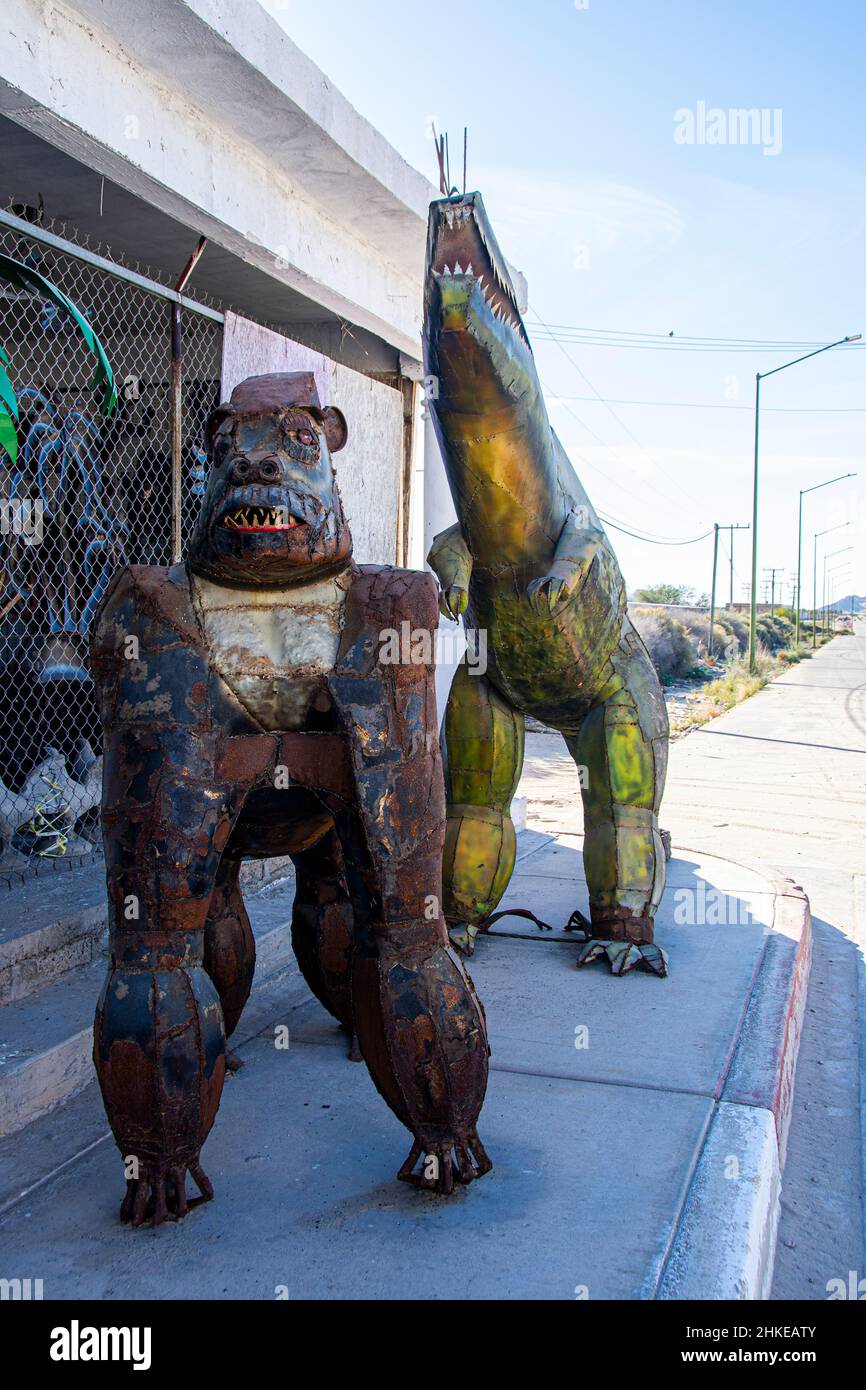 A gorilla and dinosaur. Two art pieces on display at the Art District area of Puerto Penasco, Sonora, Mexico. Both pieces are made of welded metal. Stock Photo
