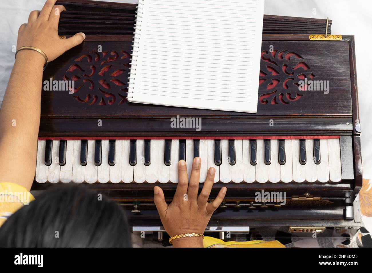Top view of harmonium being played by hands of an Indian woman Stock Photo