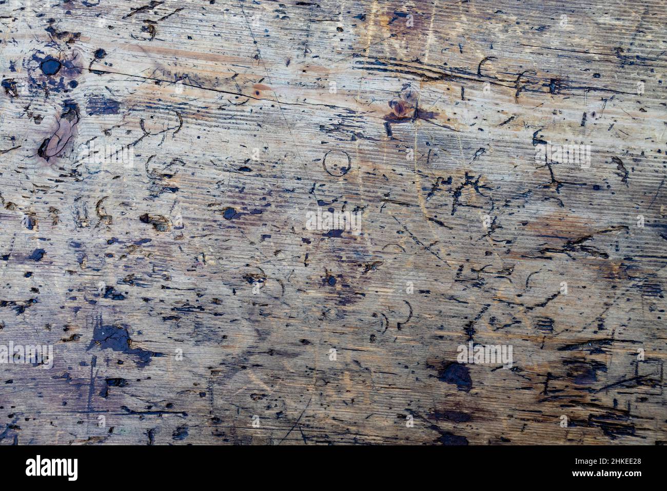 close-up of ancient wooden board ruined by knife furrows Stock Photo