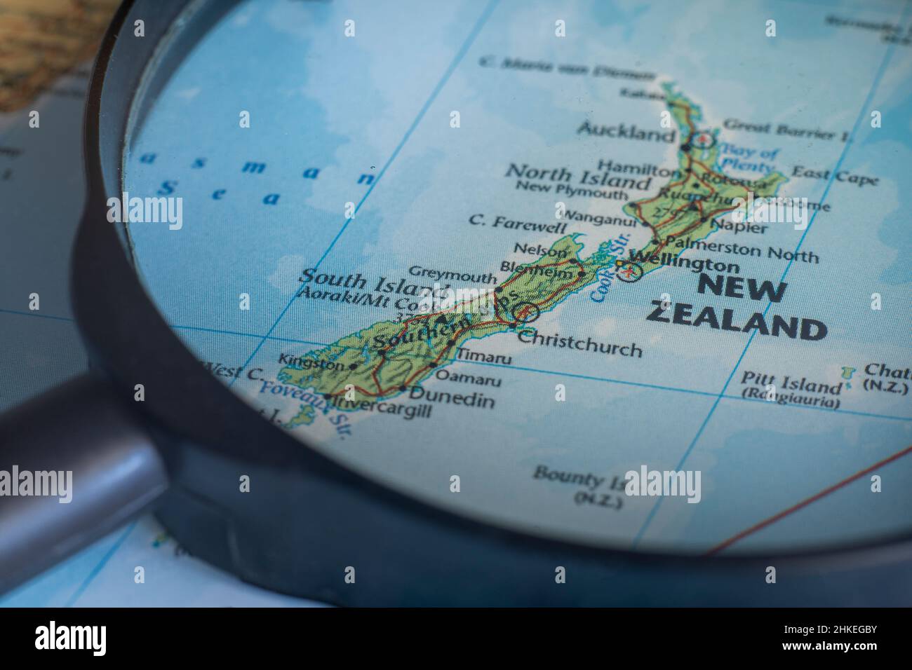 New Zealand on a world map through magnifying glass. New Zealand travel