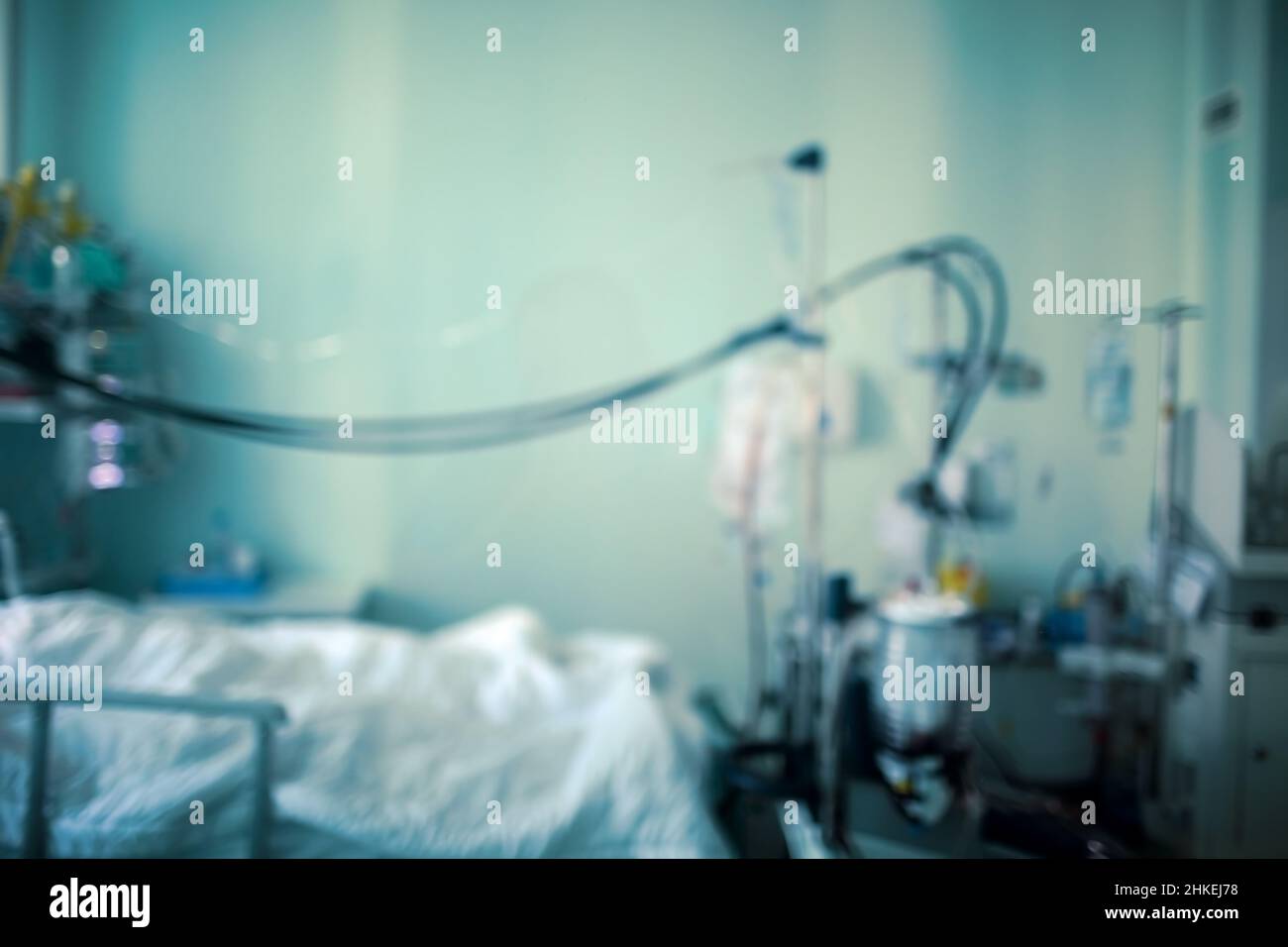 Silhouette of a patient in a small ward in the intensive care unit connected to life support equipment, unfocused background. Stock Photo