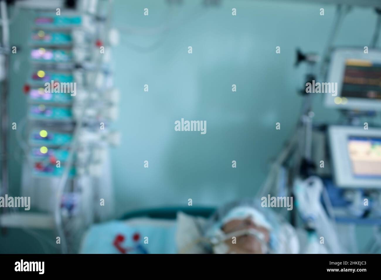 Patient under the monitoring in the ICU, unfocused background. Stock Photo
