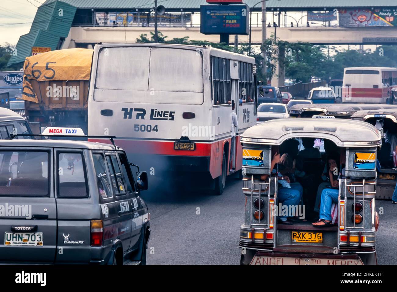 Exhaust smoke and fumes from bus in traffic on road in Manila, Philippines Stock Photo