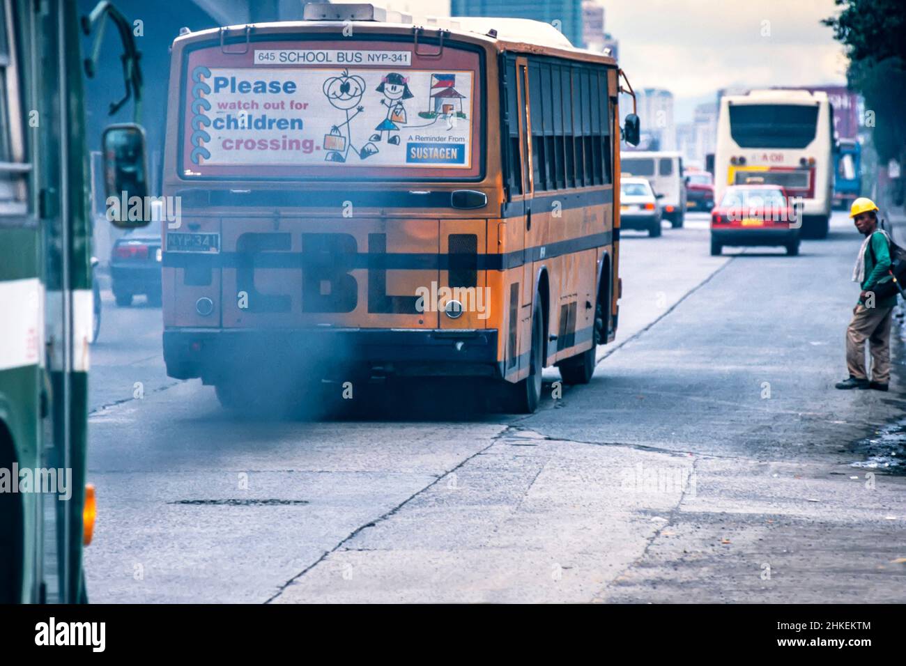 Exhaust smoke and fumes from bus in traffic on road in Manila