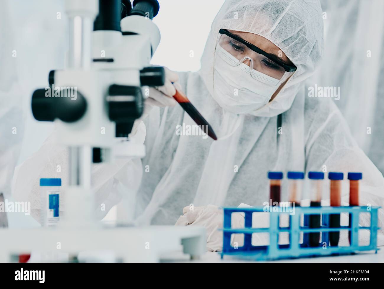 The answers are in the details. Shot of a scientist in hazmat suit conducting medical research in a laboratory. Stock Photo