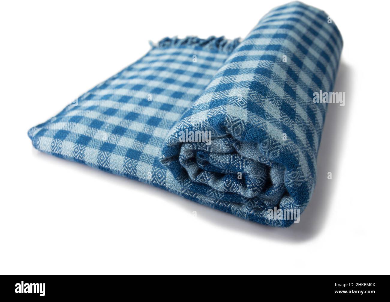 Roll of hand woven plaid shawls, Thai cotton indigo dyed isolated on white background Stock Photo