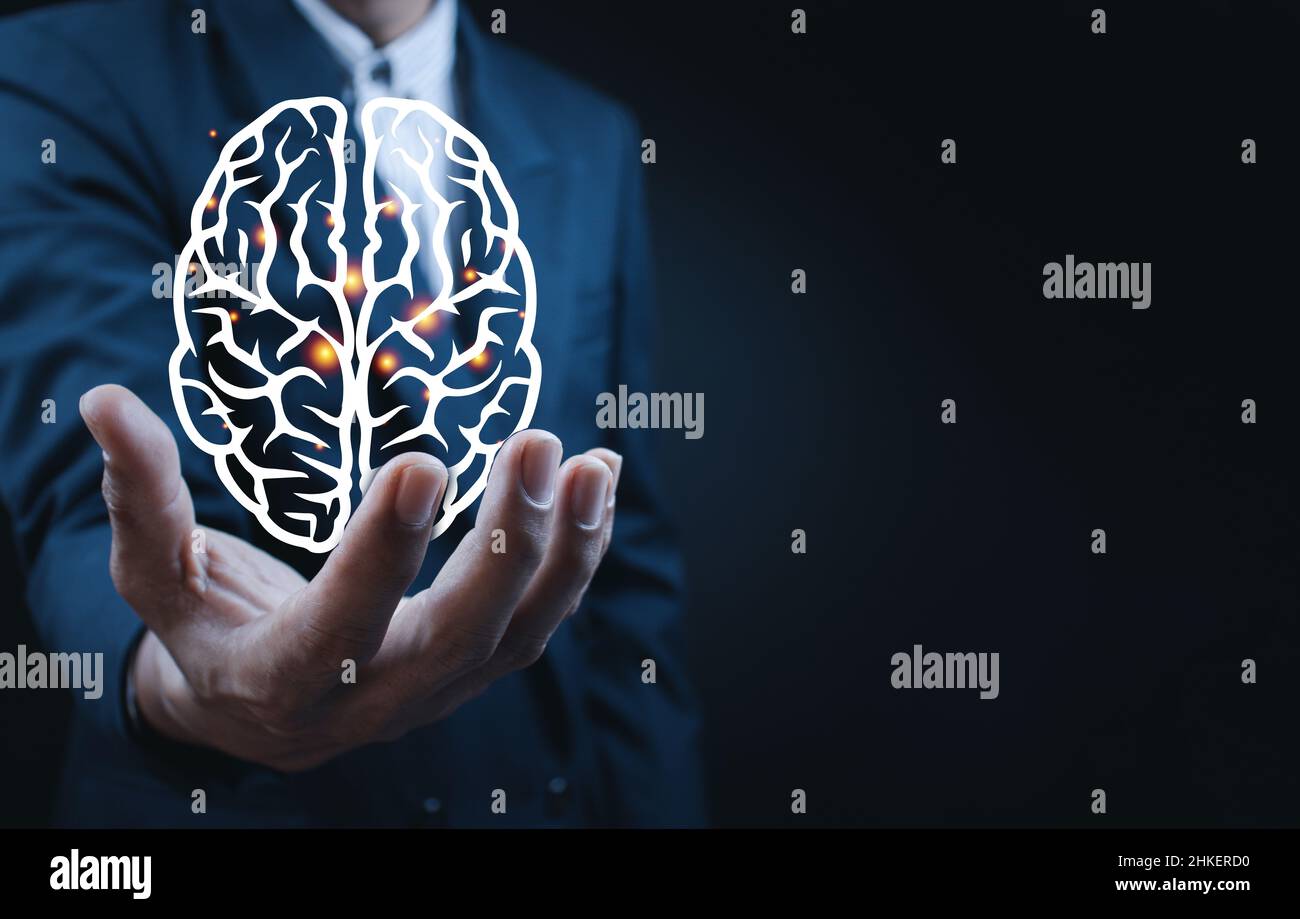 Close up of businessman holding digital image of brain Stock Photo - Alamy