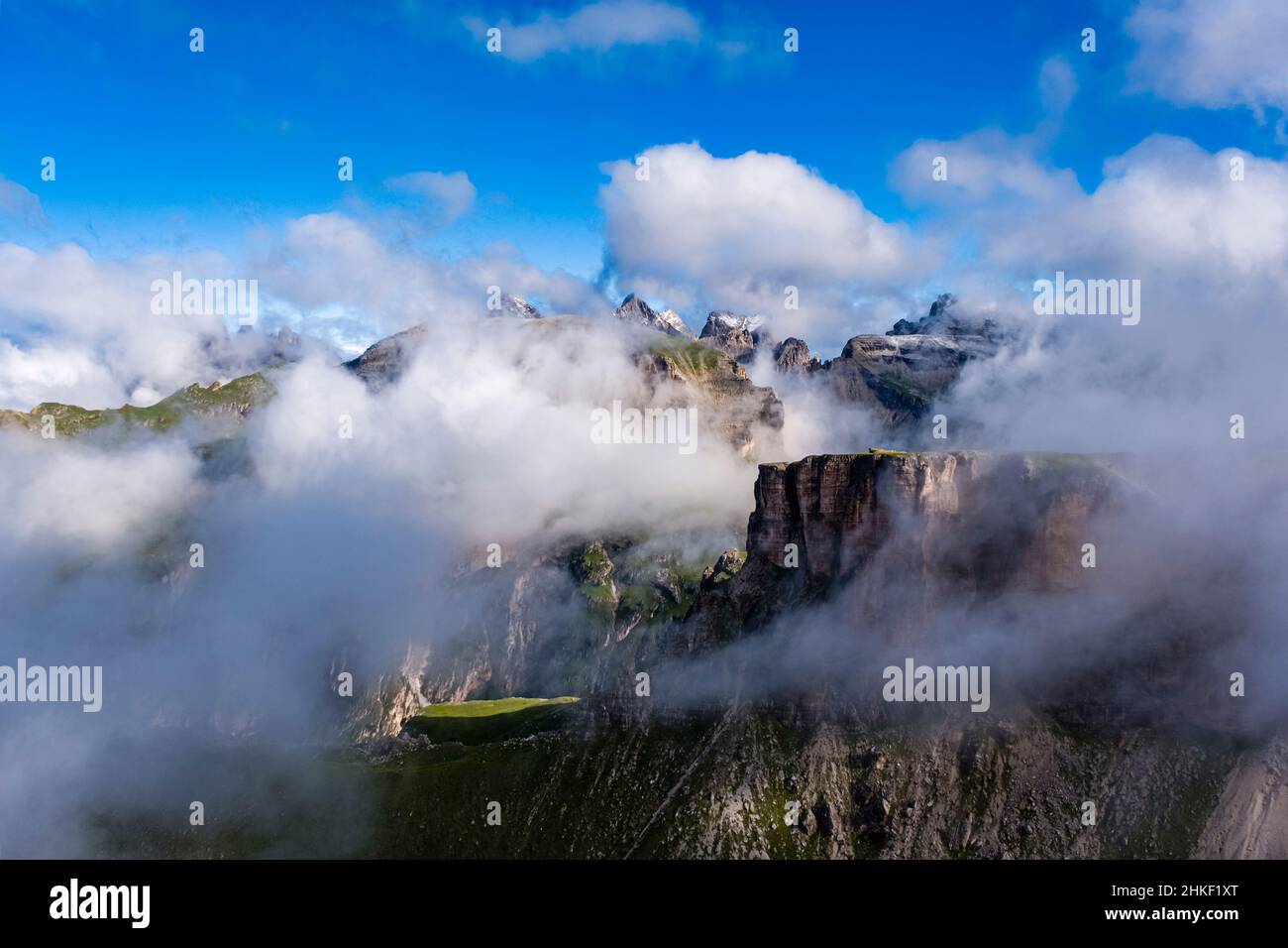 Rock faces of Puez group, covered in clouds, seen from the summit of Grand Cir. Stock Photo