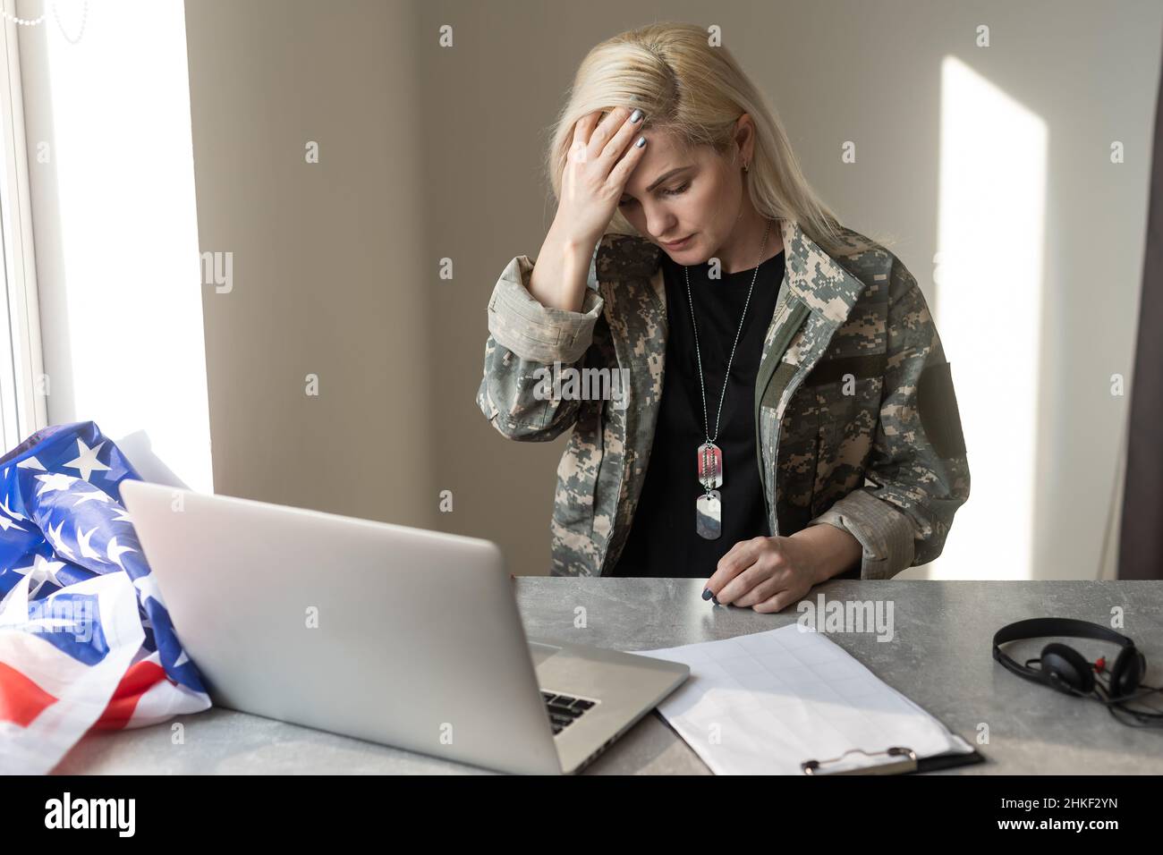 Young female soldier working with laptop in headquarters building Stock ...