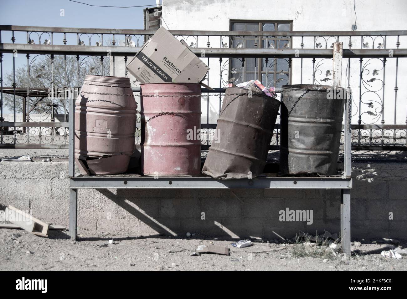 A group of four metal trash cans. Filled with garbage. Puerto Penasco, Mexico, Stock Photo