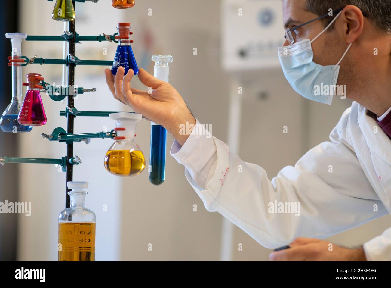Chemist with lab coat at work inside chemistry laboratory Stock Photo