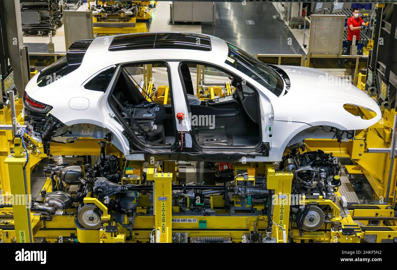 Leipzig, Germany. 02nd Feb, 2022. A Porsche Macan undergoes the so-called marriage, the joining of chassis, engine and powertrain with the body at the Porsche plant in Leipzig. Here, all three drive types (combustion engine, hybdrid and electric) are to run over one line from 2023. The automaker will start series production of the E version of its successful Macan model in Leipzig in 2023. Credit: Jan Woitas/dpa-Zentralbild/dpa/Alamy Live News Stock Photo