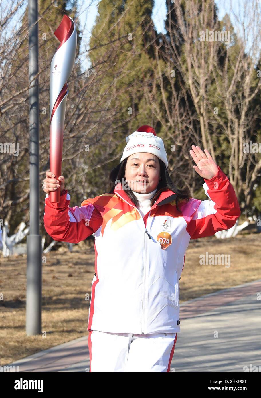 Beijing, China. 4th Feb, 2022. Torch bearer Wang Caihong runs with the torch during the Beijing 2022 Olympic Torch Relay at the Grand Canal Forest Park in Tongzhou District of Beijing, capital of China, Feb. 4, 2022. Credit: Ren Chao/Xinhua/Alamy Live News Stock Photo