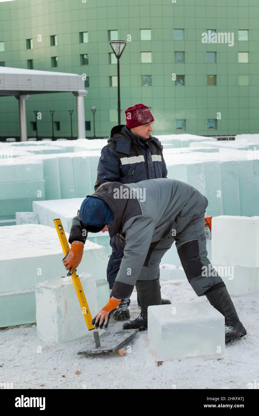 The worker puts on the level of the ice plate Stock Photo Alamy