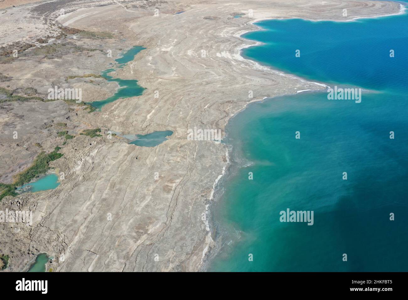 (220204) -- DEAD SEA, Feb. 4, 2022 (Xinhua) -- Aerial photo taken on Feb. 3, 2022 shows sinkholes on the shore of the Dead Sea near Ein Gedi beach, Israel. As the Dead Sea is shrinking and its water levels decreasing, hundreds of sinkholes are devouring land where the shoreline once stood. (Photo by Gil Cohen Magen/Xinhua) Stock Photo