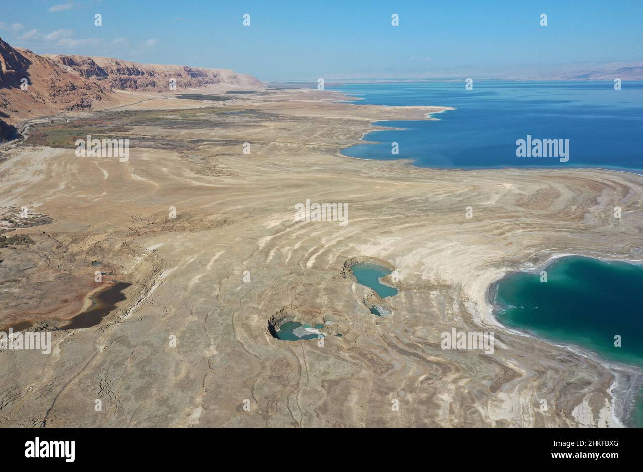 (220204) -- DEAD SEA, Feb. 4, 2022 (Xinhua) -- Aerial photo taken on Feb. 3, 2022 shows sinkholes on the shore of the Dead Sea near Ein Gedi beach, Israel. As the Dead Sea is shrinking and its water levels decreasing, hundreds of sinkholes are devouring land where the shoreline once stood. (Photo by Gil Cohen Magen/Xinhua) Stock Photo