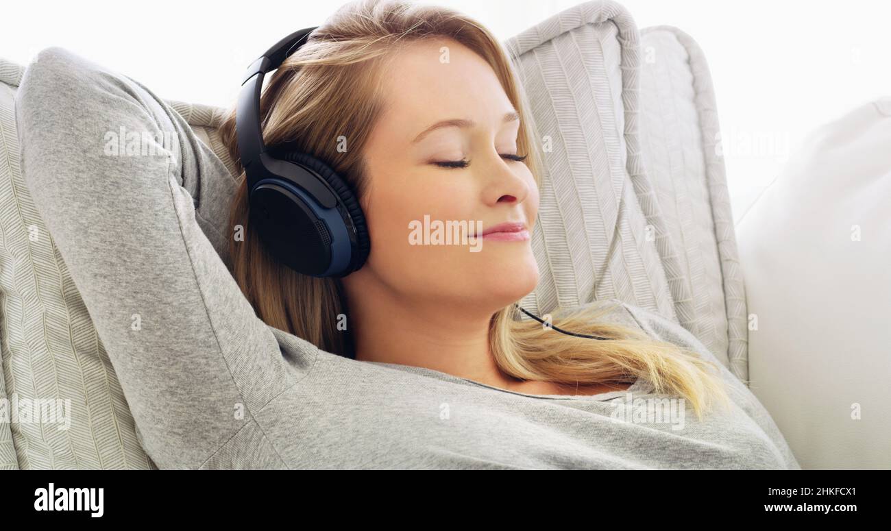 She is in her comfort zone listening to music Stock Photo