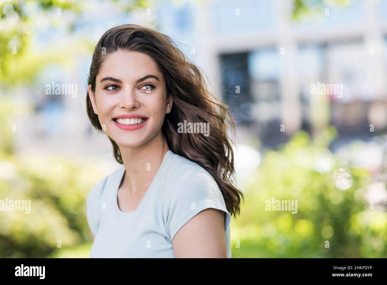 Beautiful happy young woman closeup portrait. Pretty model girl with perfect fresh clean skin smiling outdoors, Stock Photo