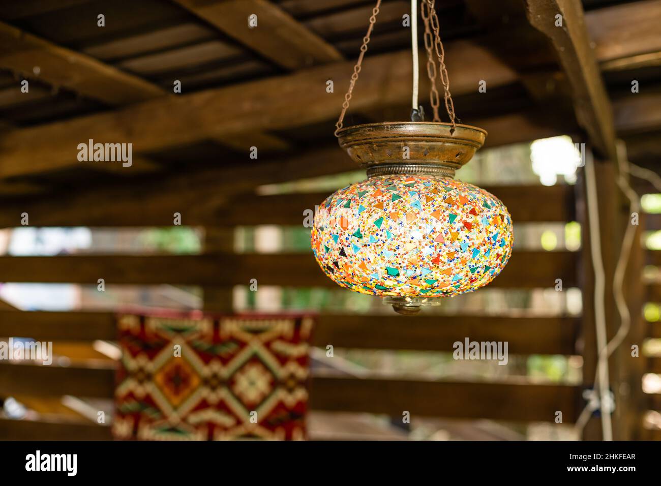 Decorating hanging lantern lamps in wooden interior. Stock Photo