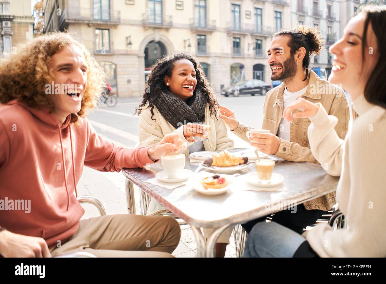 Friends group toasting latte at coffee bar terrace. Group of people talking and having fun together at cappuccino restaurant. Lifestyle concept with Stock Photo