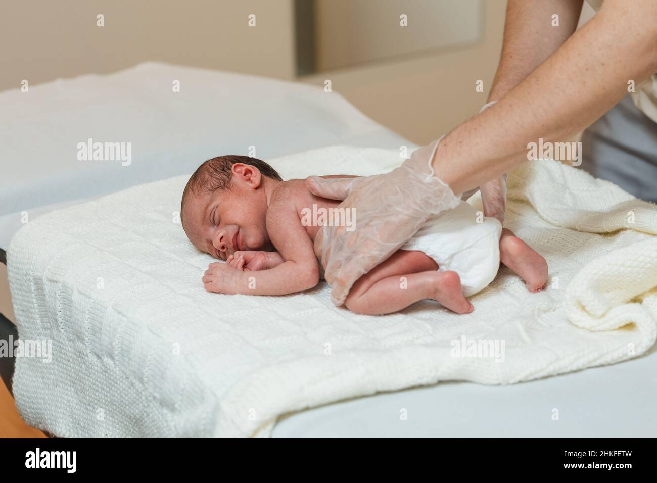 Physiotherapist performing an evaluation on the spine of a newborn baby Stock Photo Alamy