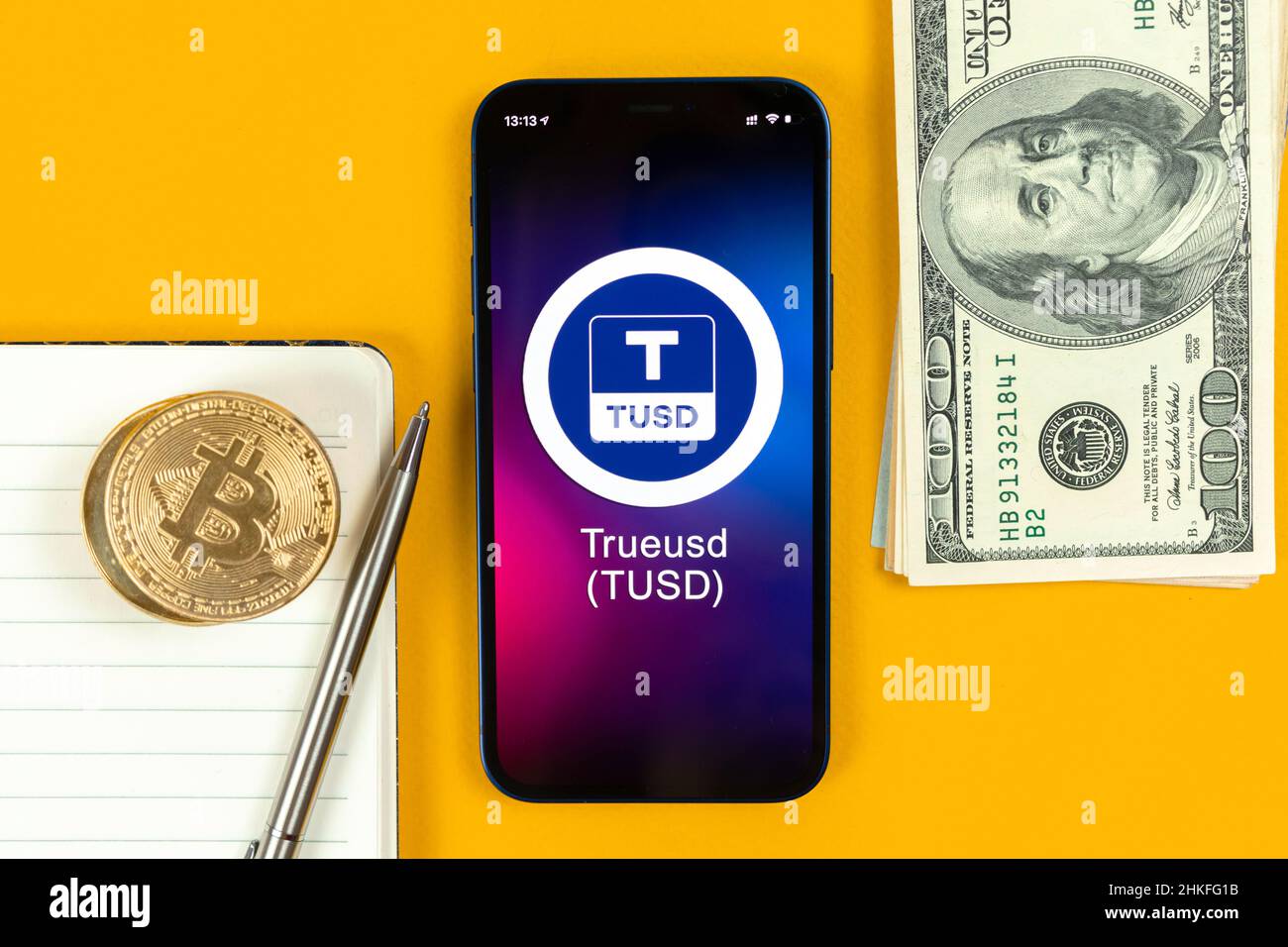 Kharkov, Ukraine - January 31, 2022: TrueUSD coin symbol. Trade with cryptocurrency, digital and virtual money, banking with mobile phone concept. Bus Stock Photo