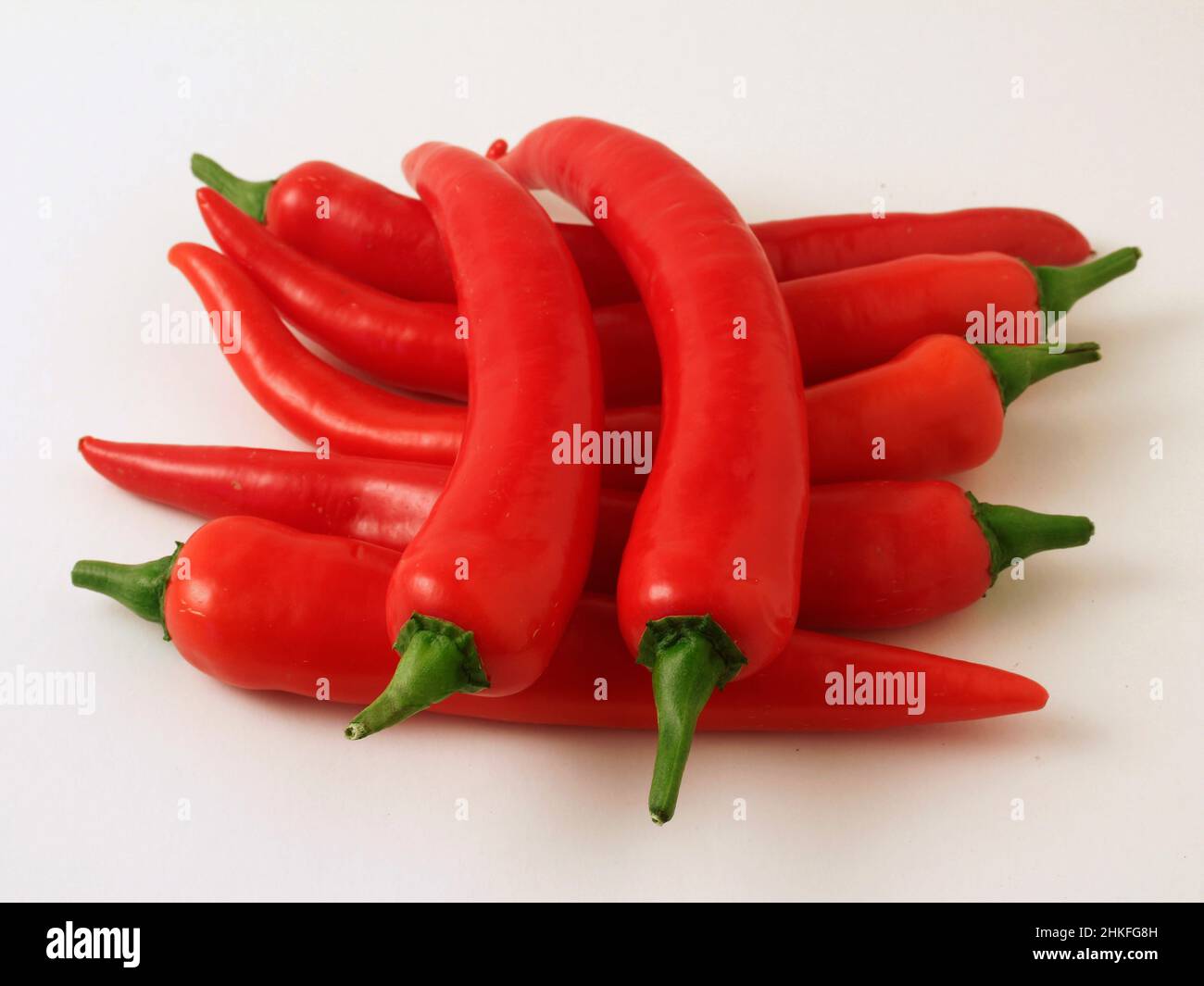 Isolated red hot chilli peppers. Stock Photo