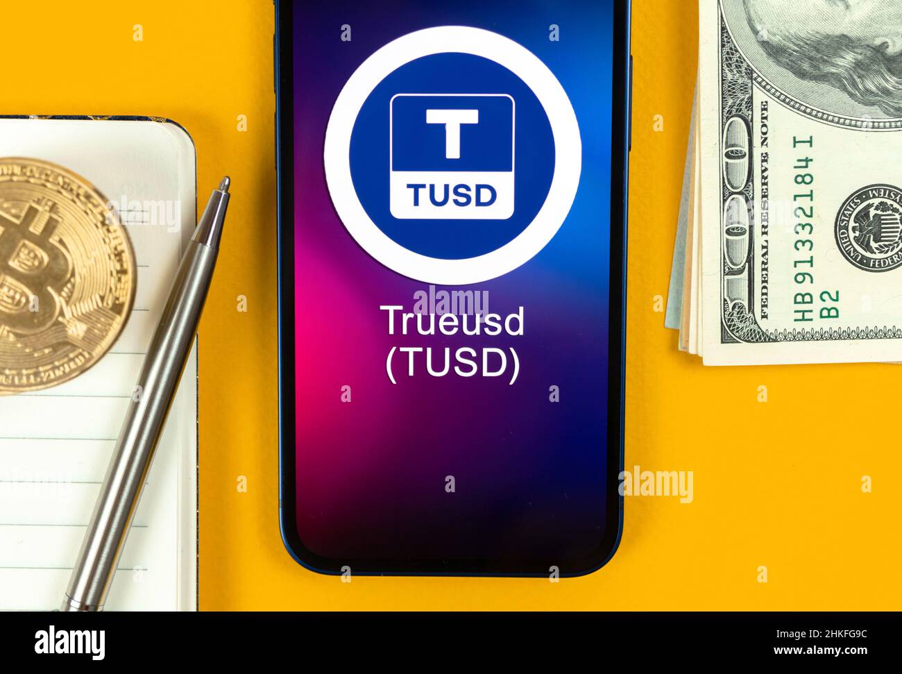 Kharkov, Ukraine - January 31, 2022: TrueUSD TUSD coin symbol. Trade with cryptocurrency, digital and virtual money, banking with mobile phone concept Stock Photo