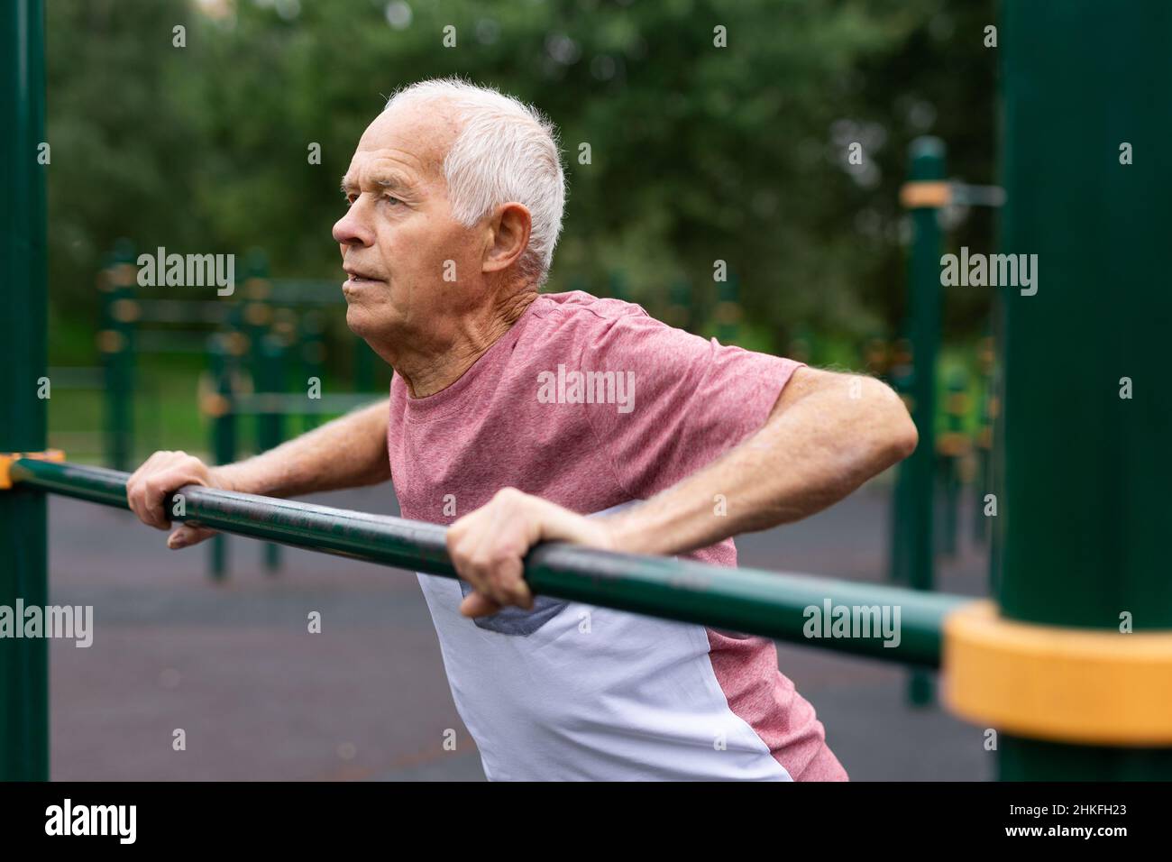 Senior european man doing push-ups outdoors Stock Photo