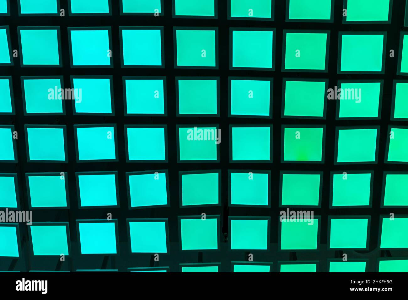 Neon vibrant green and aquamarine square tiles modern background. Stock Photo