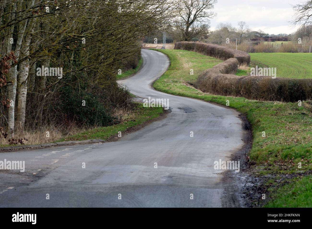 A winding country road in winter, Warwickshire, England, UK Stock Photo