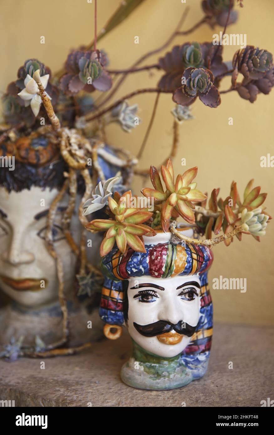 Italy, Sicily, Taormina, Moorish Sicilian ceramic flower pots depicting a couple on the terrace of Casa Cuseni, a historic villa converted into a guest house Stock Photo