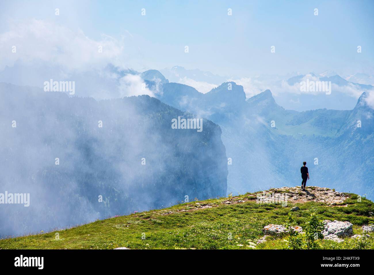 France, Haute-Savoie (74), Dingy-Saint-Clair, hiker contemplating the landscape on the edge of the Parmelan plateau Stock Photo