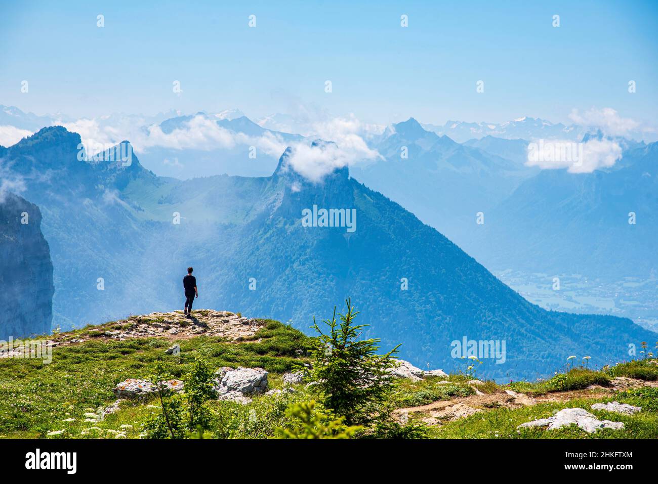 France, Haute-Savoie (74), Dingy-Saint-Clair, hiker contemplating the landscape on the edge of the Parmelan plateau Stock Photo