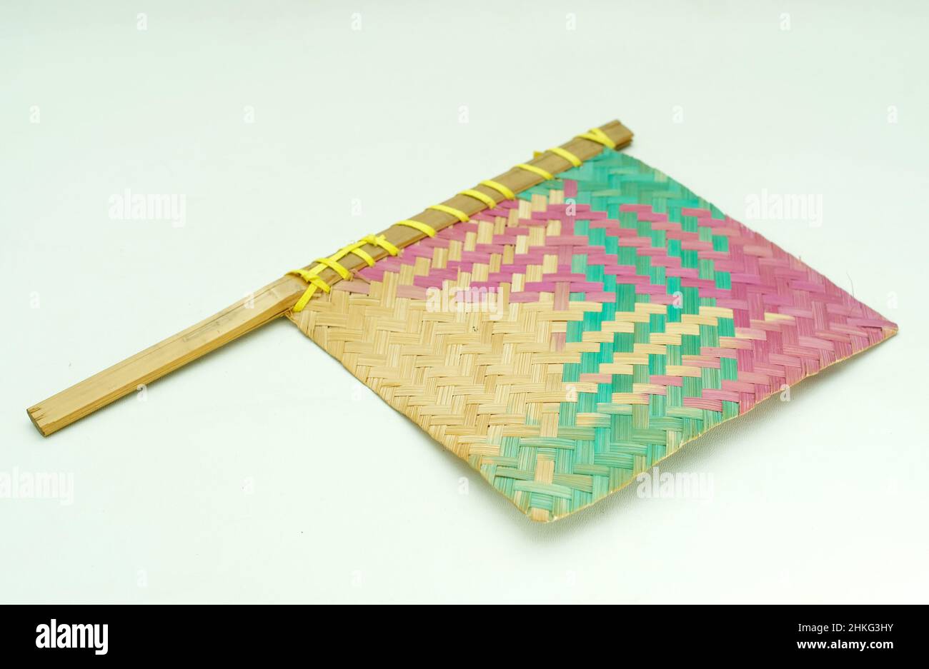 Traditional fan made of woven bamboo with a white background Stock Photo
