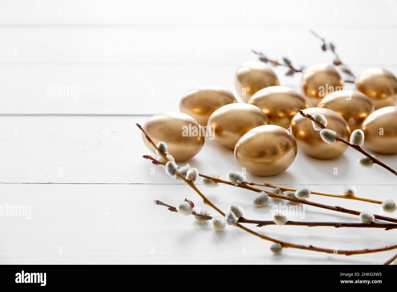 Easter eggs with pussy willow branches on white wooden table happy ...