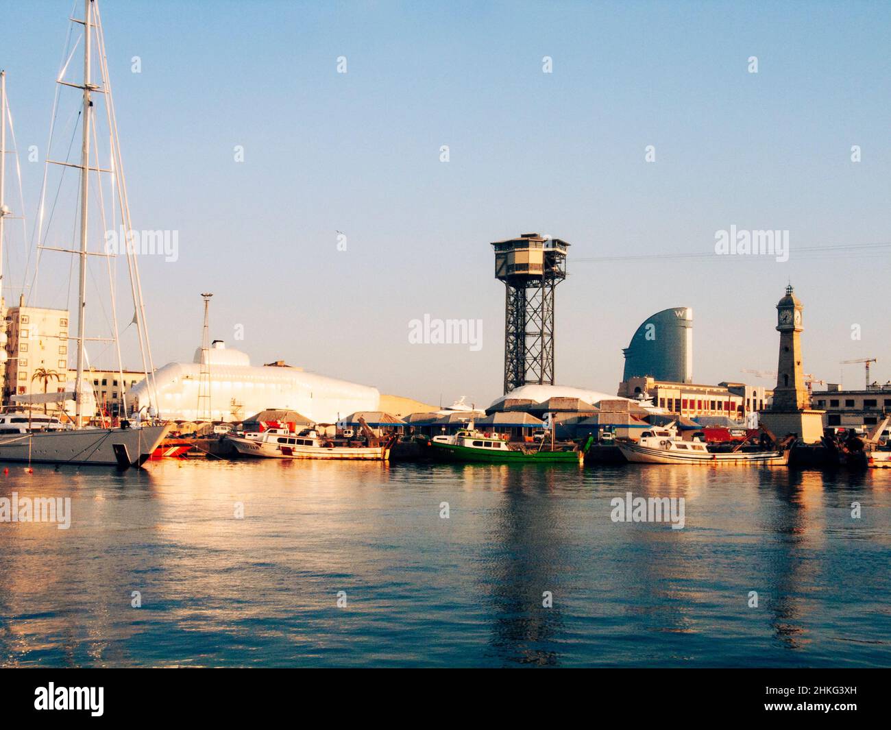 Port in Barcelona with Cable Car tower (central) and clock tower / Torre del Rellotge Barceloneta (right). Barcelona, Catalonia, Spain Stock Photo