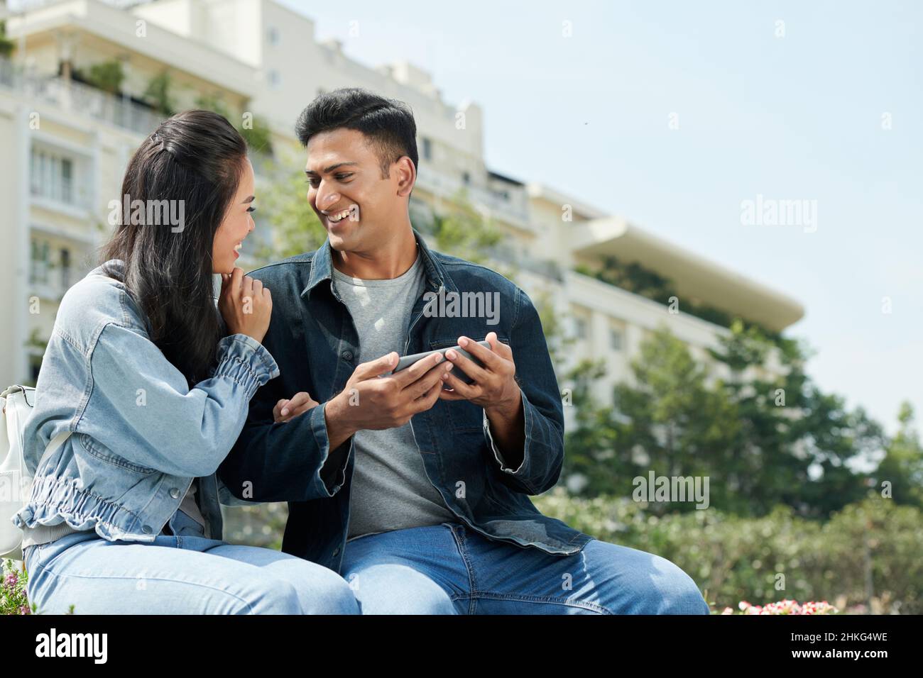 Boyfriend and girlfriend laughing and looking at each other after