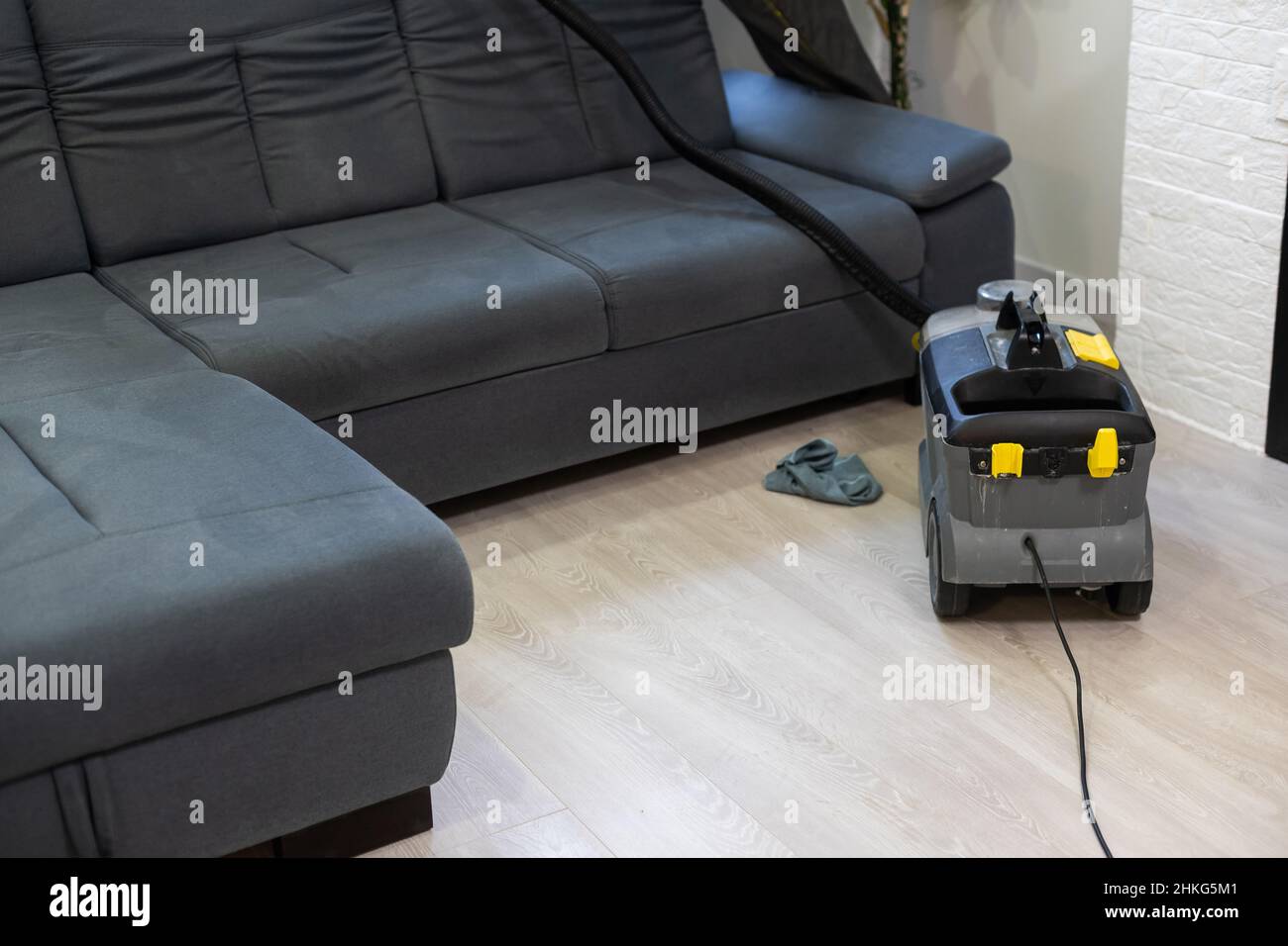 Hand cleaning a sofa with a steam cleaner, Home cleaning concept Stock  Photo - Alamy