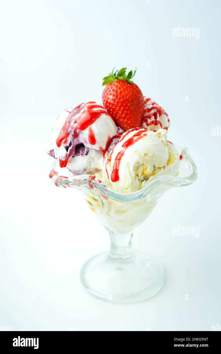 Cup with three balls of banana, cream and strawberry ice cream Stock Photo