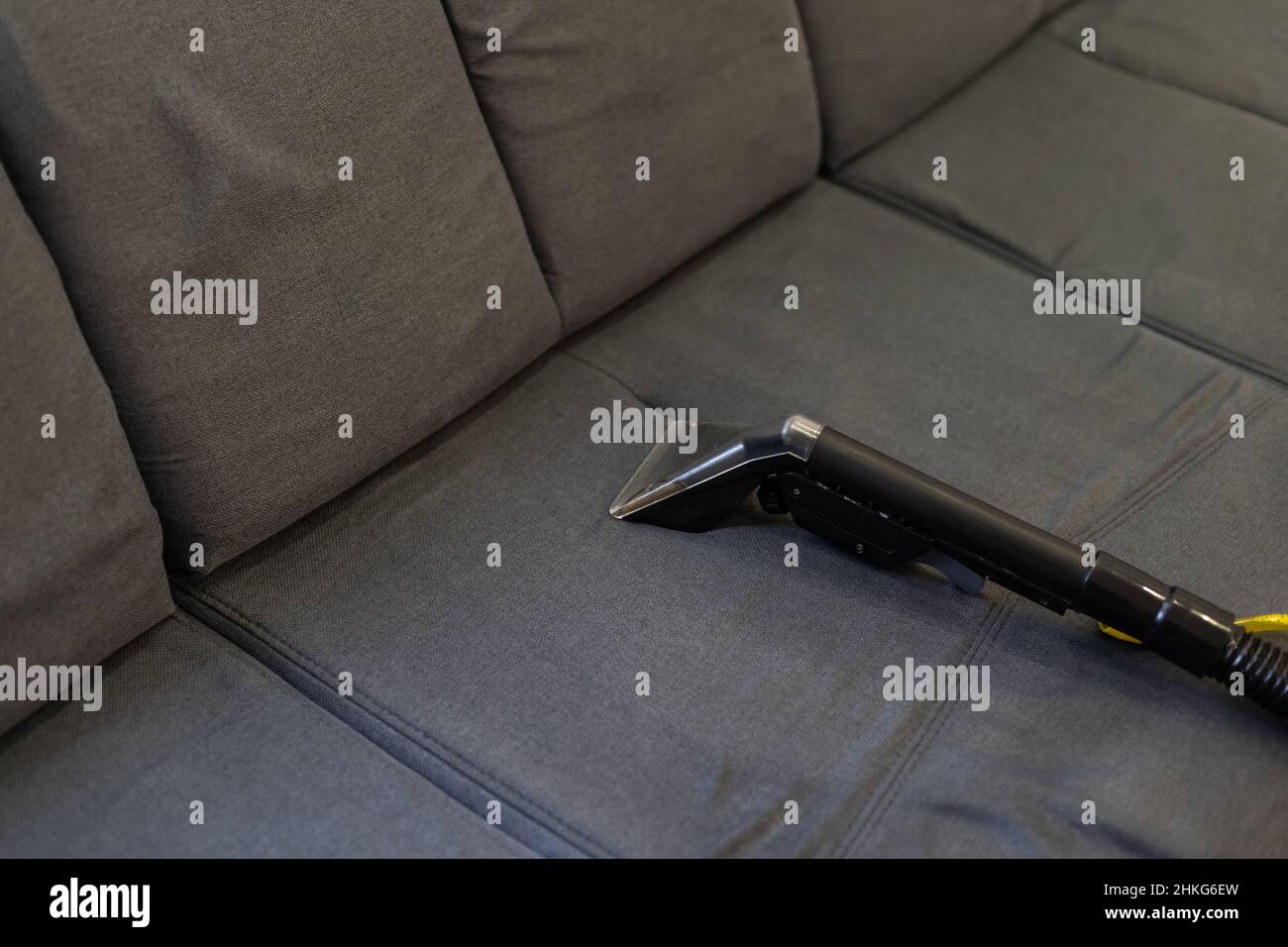 Cleaning Sofa With Vacuum Cleaner Stock Photo Alamy