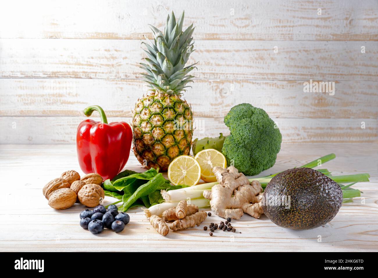 Assortment of healthy food with anti-inflammatory effect like vegetables, nuts, fruits and spices, light wooden background with copy space, selected s Stock Photo