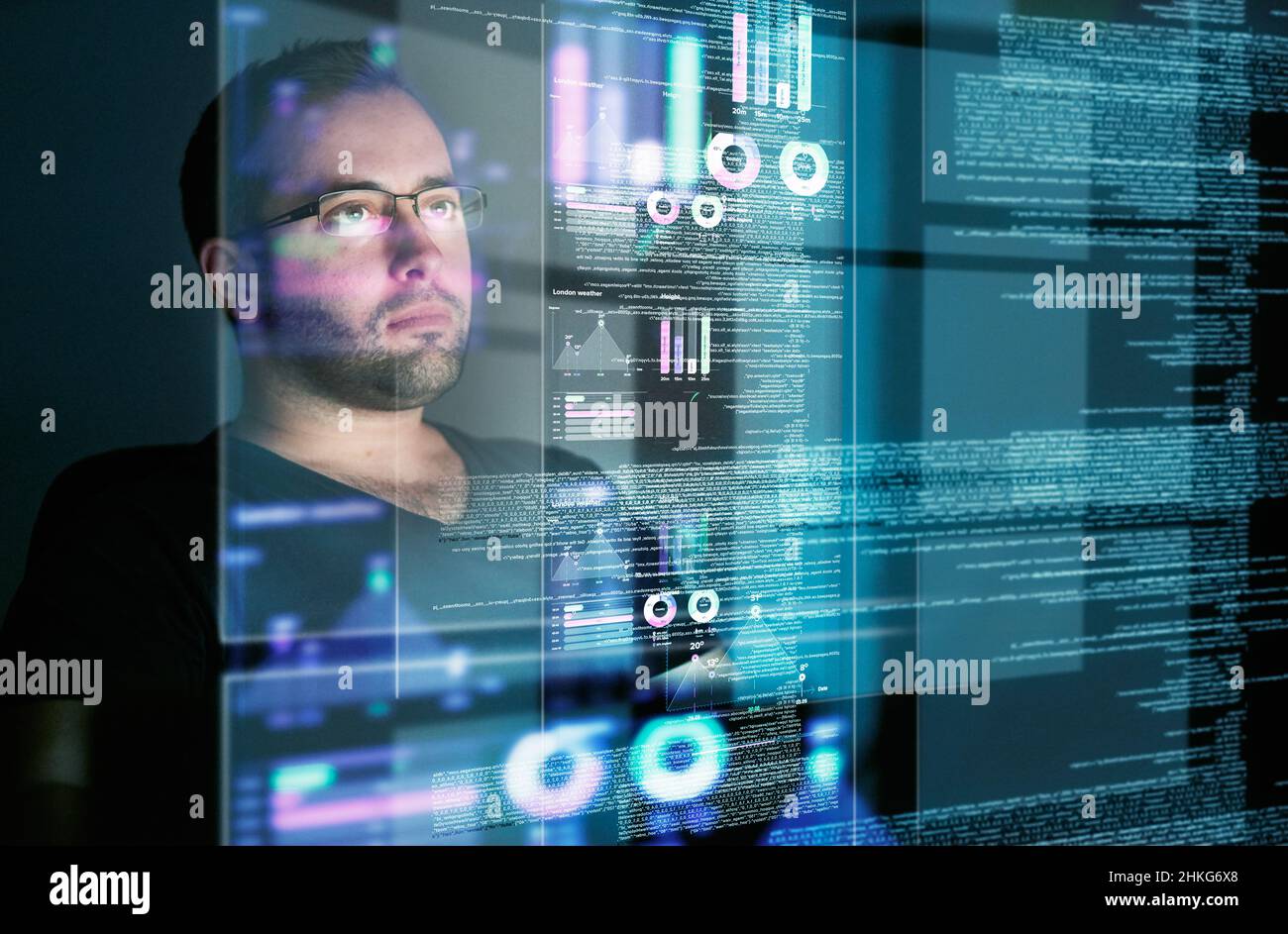 Looking over the data. Cropped shot of a young computer programmer looking through data. Stock Photo
