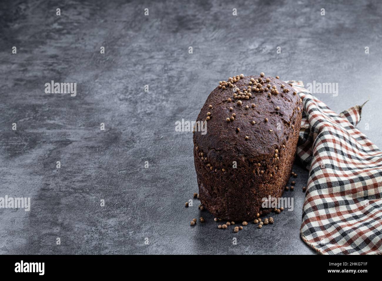 homemade-dark-rye-bread-with-coriander-seeds-on-gray-stone-background