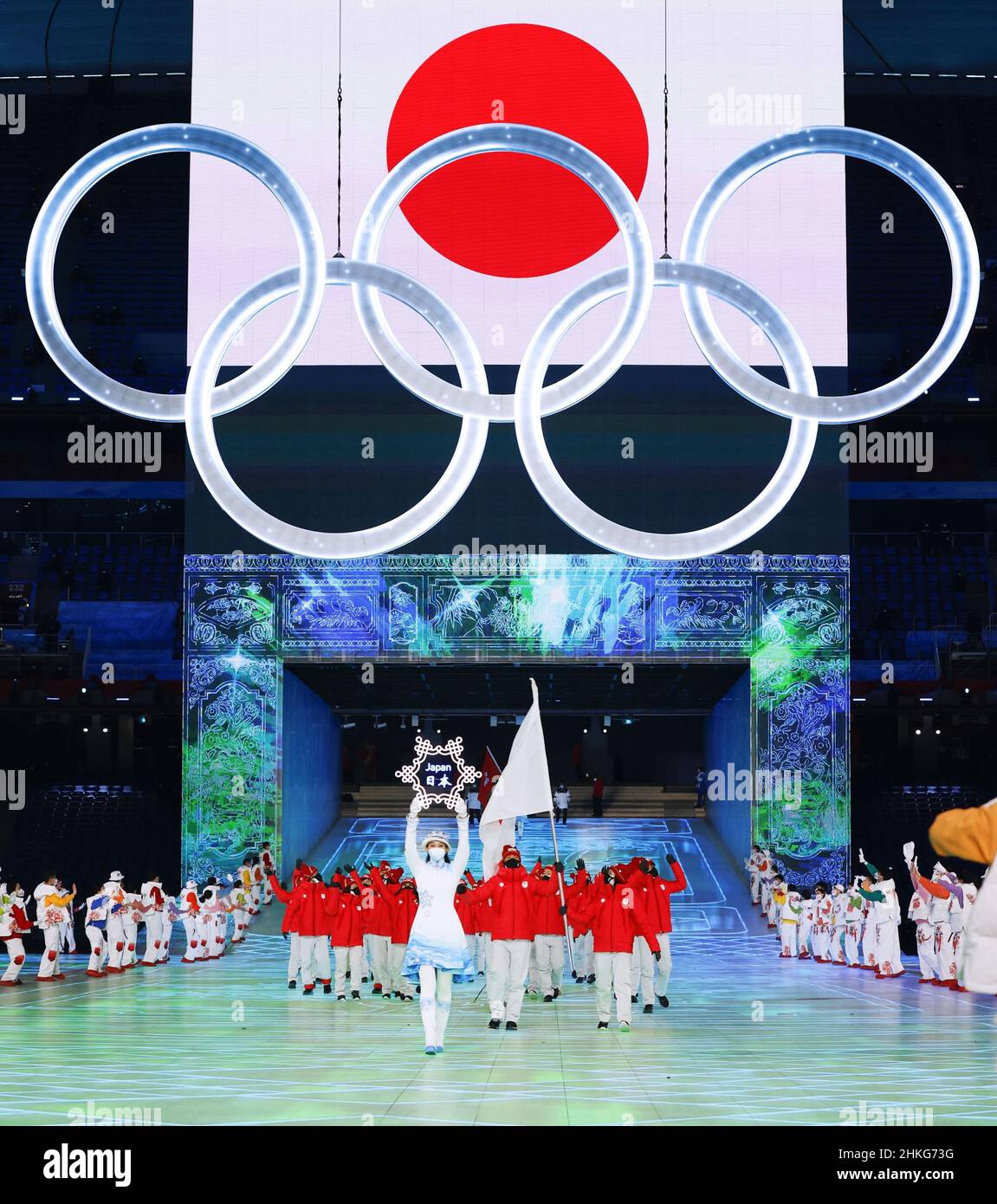 Flag bearers Arisa Go (R in front row) and Akito Watabe (L in front row) lead the Japanese