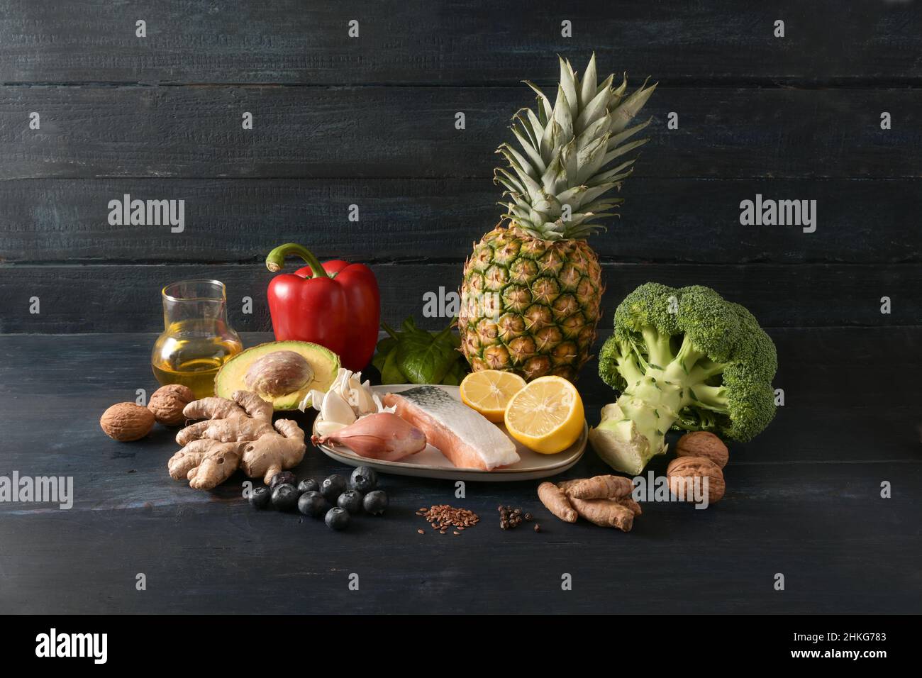 Food for health, vegetables, fish, fruits, nuts and spices for an anti-inflammatory and antioxidant diet, dark rustic wooden background with copy spac Stock Photo