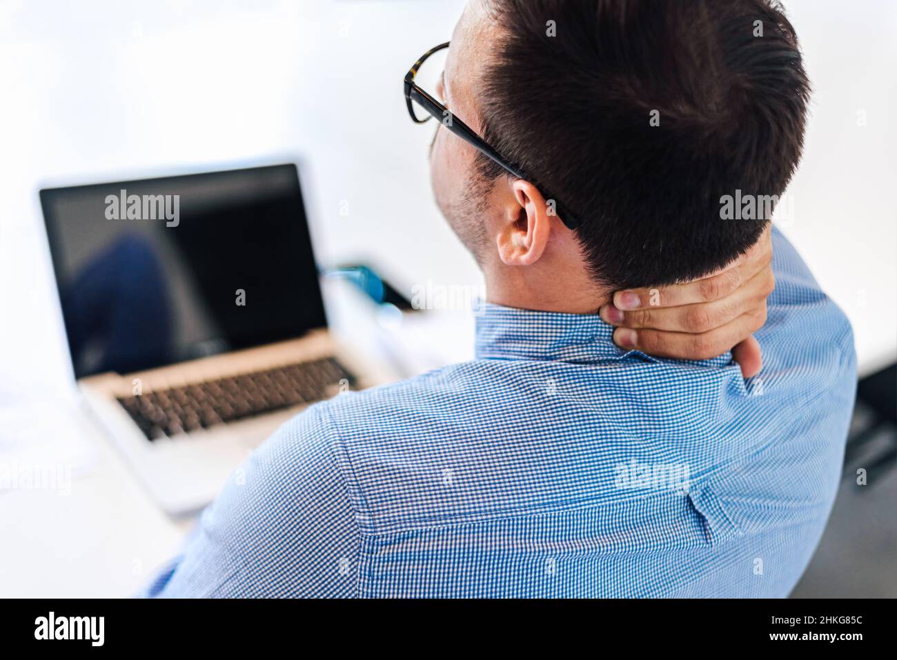 Businessman office working holding sore neck pain from desk working and