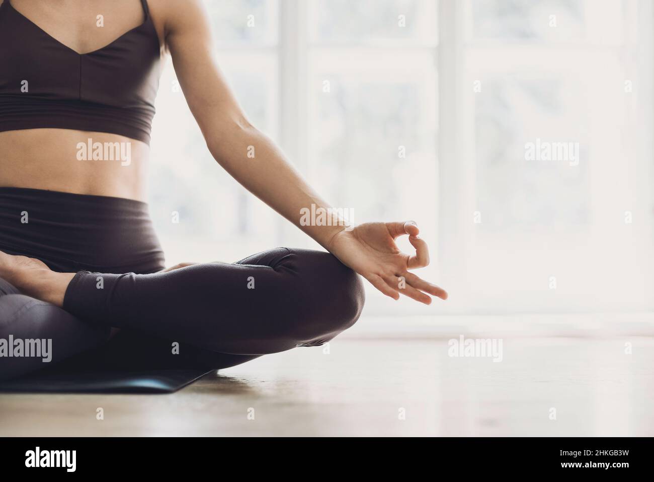 Girl doing fitness exercise, practicing yoga in class, young woman meditating.Training, fitness, workout, relaxation, healthy lifestyle concept Stock Photo