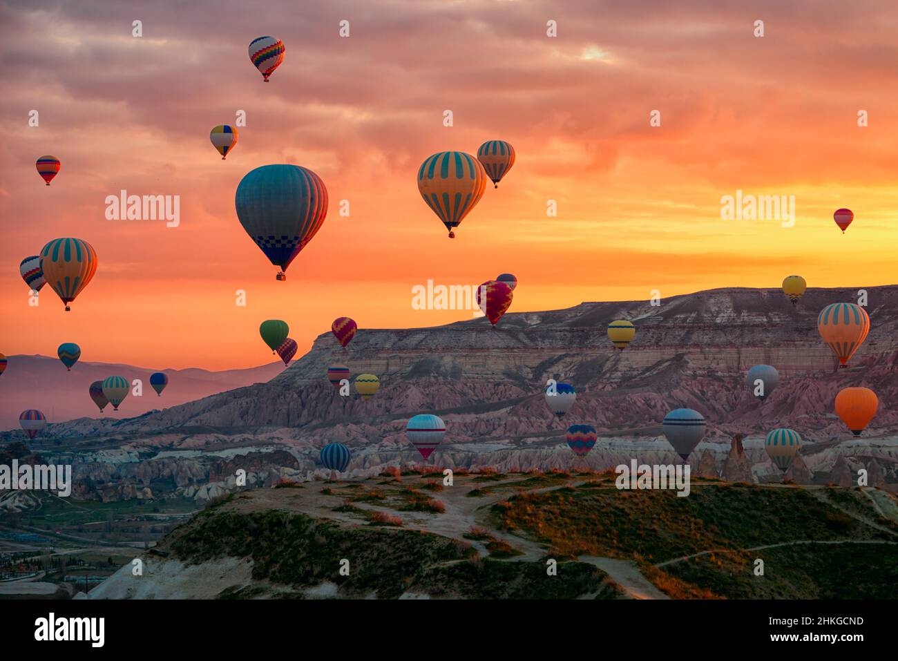 Hot Air balloons flying tour over Mountains landscape spring sunrice Cappadocia, Goreme Open Air Museum National Park, Turkey nature background. Stock Photo
